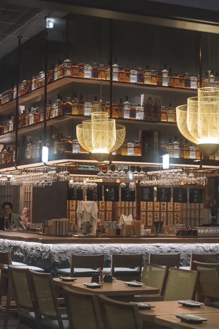 The marble bar and illuminated bottle shelves inside Genki