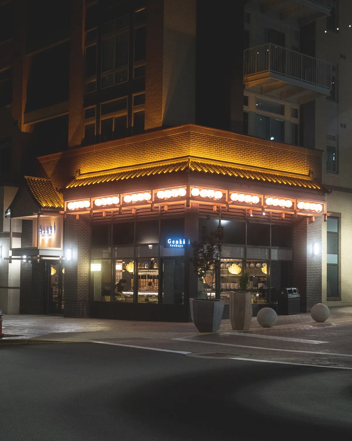 Genki Izakaya’s illuminated storefront viewed from across the street at Scout on the Circle